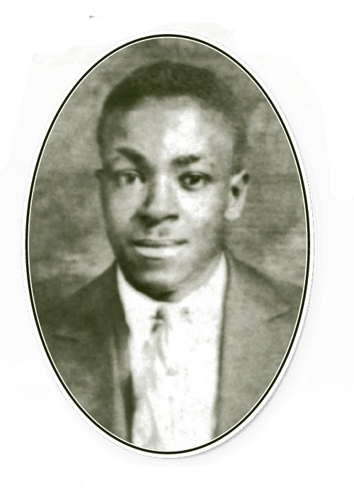 A young African American man looks into the camera with a closed-mouth smile. He is wearing a suit and tie.